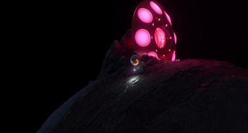 Movie still from “Blush” (2021), directed by Joe Mateo – A pink light is shining on a rock; Extreme Wide shot, Overhead angle