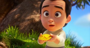 Movie still from “Blush” (2021), directed by Joe Mateo – A boy holding a banana in his hands; Close Up shot, Over the shoulder angle