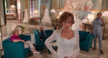 Movie still from “Book Club: The Next Chapter” (2023), directed by Bill Holderman – A woman in a wedding dress posing for a picture; Medium shot, Over the shoulder angle