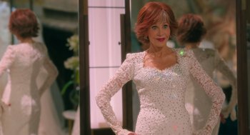 Movie still from “Book Club: The Next Chapter” (2023), directed by Bill Holderman – A woman in a white dress posing for a picture; Medium shot, Over the shoulder angle