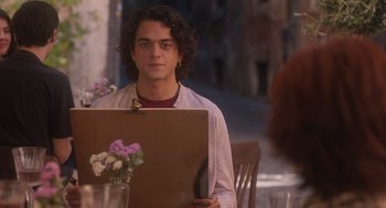 Movie still from “Book Club: The Next Chapter” (2023), directed by Bill Holderman – A man sitting in front of a laptop computer; Medium shot, Over the shoulder angle