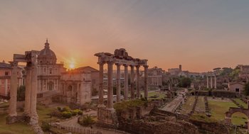 Movie still from “Book Club: The Next Chapter” (2023), directed by Bill Holderman – An ancient roman ruins with the sun setting in the background; Extreme Wide shot, Low angle