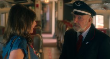 Movie still from “Book Club: The Next Chapter” (2023), directed by Bill Holderman – A man and a woman are talking on a train; Medium shot, Over the shoulder angle