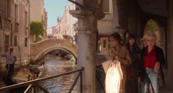 Movie still from “Book Club: The Next Chapter” (2023), directed by Bill Holderman – Two women are walking down the side of a canal; Wide shot, Over the shoulder angle