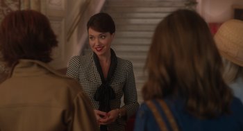 Movie still from “Book Club: The Next Chapter” (2023), directed by Bill Holderman – A woman in a black and white dress is smiling; Medium shot, Over the shoulder angle