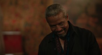 Movie still from “Book Club: The Next Chapter” (2023), directed by Bill Holderman – An older black man smiling with his eyes closed; Close Up shot, Over the shoulder angle