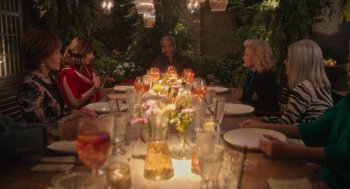 Movie still from “Book Club: The Next Chapter” (2023), directed by Bill Holderman – A group of people sitting around a table with a lot of food; Wide shot, Over the shoulder angle