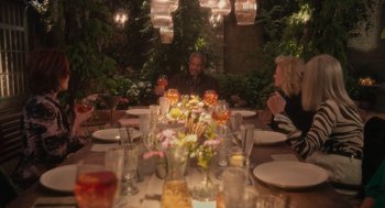 Movie still from “Book Club: The Next Chapter” (2023), directed by Bill Holderman – A group of people sitting at a table with plates of food; Wide shot, Over the shoulder angle