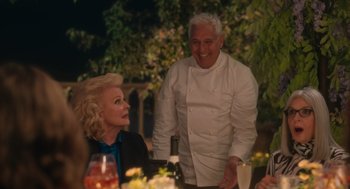 Movie still from “Book Club: The Next Chapter” (2023), directed by Bill Holderman – A man and a woman standing next to each other at a table; Medium shot, Over the shoulder angle