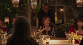 Movie still from “Book Club: The Next Chapter” (2023), directed by Bill Holderman – A man and a woman sitting at a dinner table; Medium shot, Over the shoulder angle