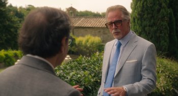 Movie still from “Book Club: The Next Chapter” (2023), directed by Bill Holderman – A man wearing a suit and tie talking to another man; Medium shot, Over the shoulder angle