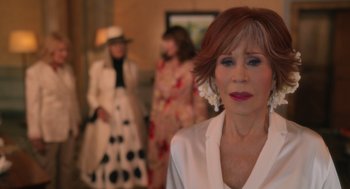 Movie still from “Book Club: The Next Chapter” (2023), directed by Bill Holderman – A woman in a white jacket standing in front of two other women; Close Up shot, Over the shoulder angle