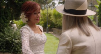 Movie still from “Book Club: The Next Chapter” (2023), directed by Bill Holderman – A woman wearing a white dress and a hat; Close Up shot, Over the shoulder angle