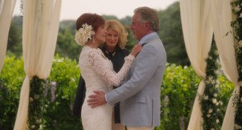 Movie still from “Book Club: The Next Chapter” (2023), directed by Bill Holderman – A man and a woman standing next to each other in front of another man; Medium shot, Over the shoulder angle