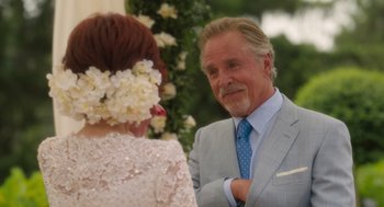 Movie still from “Book Club: The Next Chapter” (2023), directed by Bill Holderman – An older man in a gray suit and a woman in a white dress; Close Up shot, Over the shoulder angle