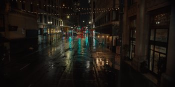 Movie still from “Books of Blood” (2020), directed by Brannon Braga – A city street at night lit up by street lights; Extreme Wide shot, High angle
