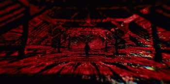 Movie still from “Books of Blood” (2020), directed by Brannon Braga – A person standing in a room with red lights; Extreme Wide shot, High angle