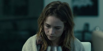 Movie still from “Books of Blood” (2020), directed by Brannon Braga – A woman is looking down at a wine glass in her hand; Close Up shot, Over the shoulder angle