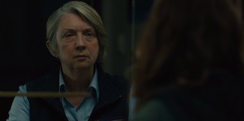 Movie still from “Books of Blood” (2020), directed by Brannon Braga – An older woman looking at the reflection of herself in a mirror; Close Up shot, Over the shoulder angle