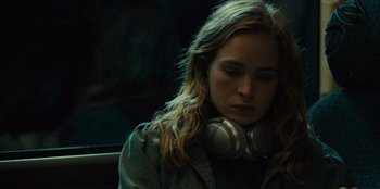Movie still from “Books of Blood” (2020), directed by Brannon Braga – A woman with headphones sitting in a car; Close Up shot, Over the shoulder angle