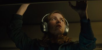 Movie still from “Books of Blood” (2020), directed by Brannon Braga – A woman wearing headphones looking up into the sky; Close Up shot, Low angle