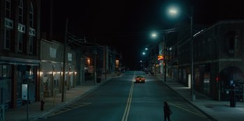 Movie still from “Books of Blood” (2020), directed by Brannon Braga – A car drives down a street at night; Extreme Wide shot, High angle