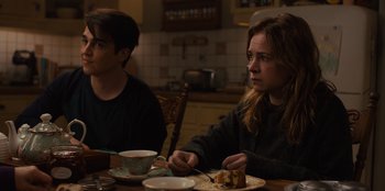 Movie still from “Books of Blood” (2020), directed by Brannon Braga – Two people sitting at a table with a plate of food; Medium shot, Over the shoulder angle