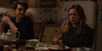 Movie still from “Books of Blood” (2020), directed by Brannon Braga – A woman sitting at a table with a piece of cake; Medium shot, Over the shoulder angle