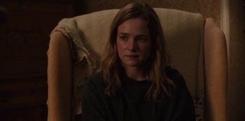Movie still from “Books of Blood” (2020), directed by Brannon Braga – A woman sitting in a chair looking at the camera; Close Up shot, Over the shoulder angle