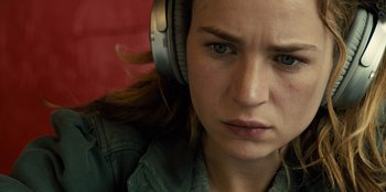 Movie still from “Books of Blood” (2020), directed by Brannon Braga – A person wearing headphones and looking sad; Close Up shot, Over the shoulder angle