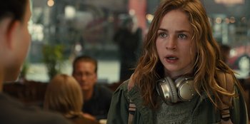 Movie still from “Books of Blood” (2020), directed by Brannon Braga – A woman with headphones is standing in front of a group of people; Close Up shot, Over the shoulder angle