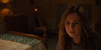 Movie still from “Books of Blood” (2020), directed by Brannon Braga – A woman sitting on a bed in a room; Close Up shot, Over the shoulder angle