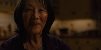 Movie still from “Books of Blood” (2020), directed by Brannon Braga – An older asian woman is looking at the camera; Extreme Close Up shot, High angle