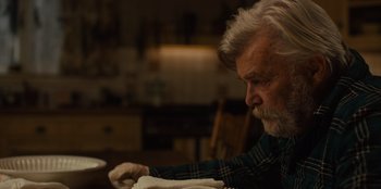 Movie still from “Books of Blood” (2020), directed by Brannon Braga – An older man sitting at a table with a plate in front of him; Close Up shot, Over the shoulder angle