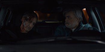 Movie still from “Books of Blood” (2020), directed by Brannon Braga – Two men sitting in the back seat of a car; Close Up shot, Over the shoulder angle