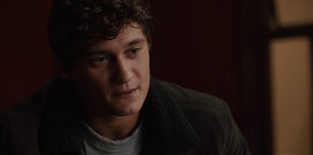 Movie still from “Books of Blood” (2020), directed by Brannon Braga – A man with curly hair wearing a jacket looking to his left; Close Up shot, Over the shoulder angle