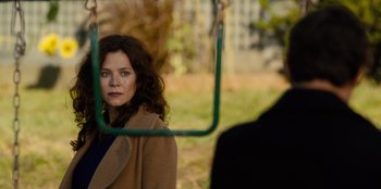 Movie still from “Books of Blood” (2020), directed by Brannon Braga – A woman sitting on a swing in a park; Close Up shot, Over the shoulder angle
