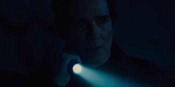 Movie still from “Books of Blood” (2020), directed by Brannon Braga – A man holding a flashlight up to his face; Close Up shot, Low angle