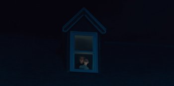Movie still from “Books of Blood” (2020), directed by Brannon Braga – A person looking out of a window at night; Wide shot, Low angle