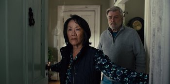 Movie still from “Books of Blood” (2020), directed by Brannon Braga – An older man and a younger woman standing in front of a door; Medium shot, Over the shoulder angle