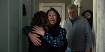 Movie still from “Books of Blood” (2020), directed by Brannon Braga – Two women hugging in front of two men; Medium shot, Over the shoulder angle