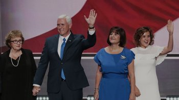 Movie still from “Borat Subsequent Moviefilm” (2020), directed by Jason Woliner – A man and a woman standing next to each other on a stage; Medium shot, Low angle
