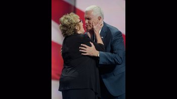 Movie still from “Borat Subsequent Moviefilm” (2020), directed by Jason Woliner – A man and a woman embracing on stage; Medium shot, Low angle