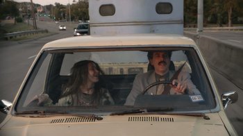 Movie still from “Borat Subsequent Moviefilm” (2020), directed by Jason Woliner – A man and a woman in the back seat of a car; Medium shot, Over the shoulder angle