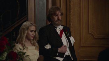 Movie still from “Borat Subsequent Moviefilm” (2020), directed by Jason Woliner – A man and a woman dressed in formal wear; Medium shot, Low angle