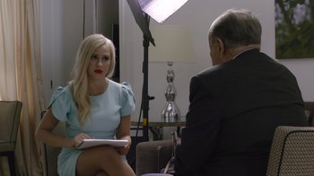 Movie still from “Borat Subsequent Moviefilm” (2020), directed by Jason Woliner – A woman sitting on the ground in front of an older man; Medium shot, Over the shoulder angle