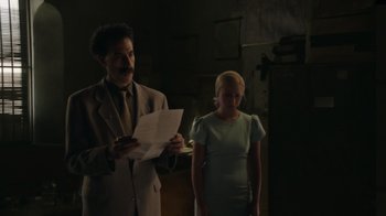 Movie still from “Borat Subsequent Moviefilm” (2020), directed by Jason Woliner – A man and a woman standing next to each other in a room; Medium shot, Low angle