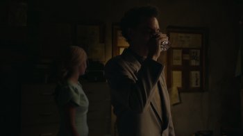 Movie still from “Borat Subsequent Moviefilm” (2020), directed by Jason Woliner – A man and a woman are drinking from a glass; Medium shot, Over the shoulder angle