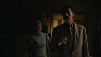 Movie still from “Borat Subsequent Moviefilm” (2020), directed by Jason Woliner – A man and a woman standing in a dimly - lit room; Medium shot, Low angle