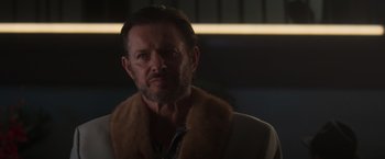 Movie still from “Born a Champion” (2021), directed by Alex Ranarivelo – A person wearing a fur coat; Close Up shot, Low angle